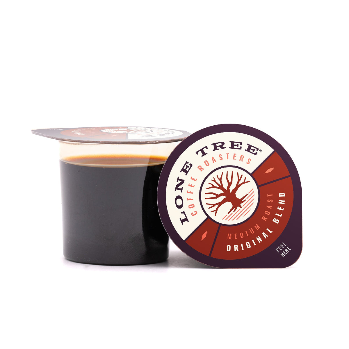 Medium roast coffee beans from Lone Tree Coffee Roasters' Original Blend, displayed in a natural setting.