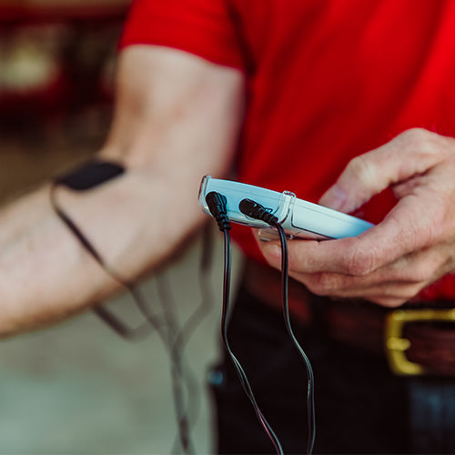 iReliev extra long TENS lead wires attached to TENS unit, showcasing durable accessories for pain relief therapy.