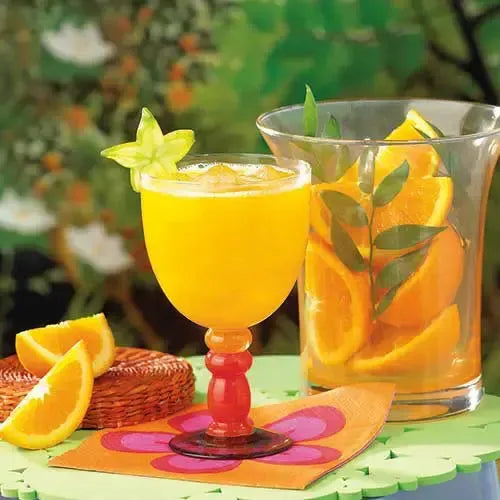 A glass of orange fruit drink from AmBari Nutrition featuring vibrant orange color and fresh fruit slices, ideal for a healthy beverage.