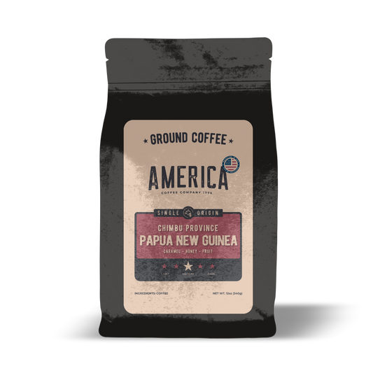 Ground Papua New Guinea single origin coffee from America Supply Company LLC, showing rich brown coffee grounds in the image.