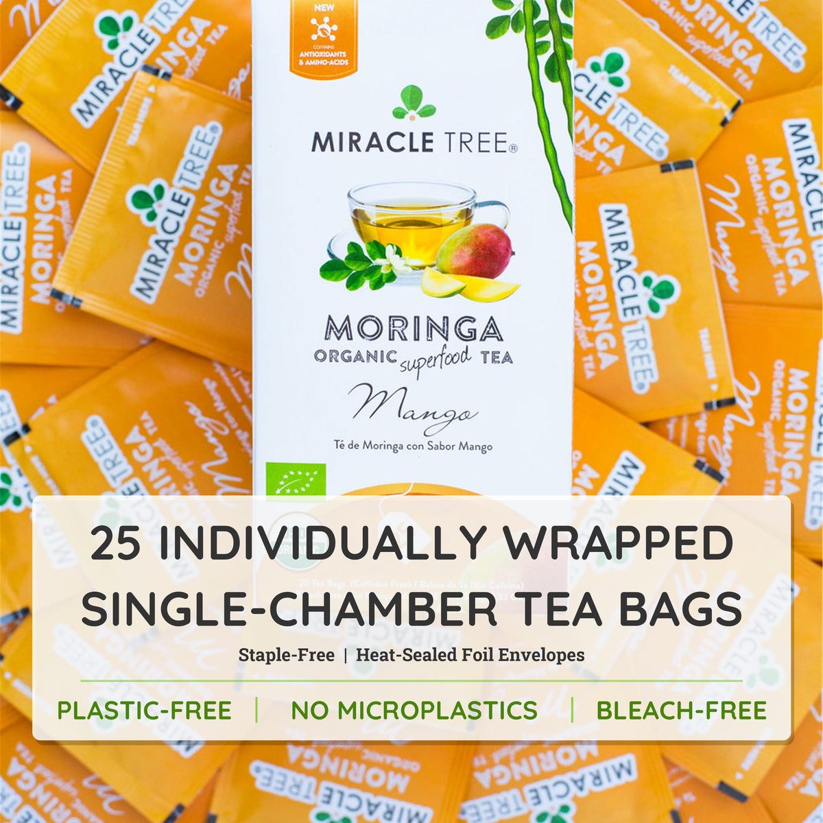 Organic Moringa Mango Herbal Tea by Miracle Tree in a clear glass cup with tea leaves and mango slices.