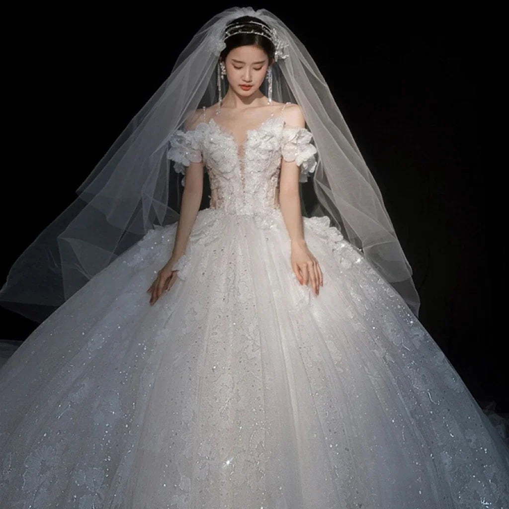 Luxurious wedding gown by EdleessFashion with shiny applique and sweetheart neckline, ideal for bridal elegance.