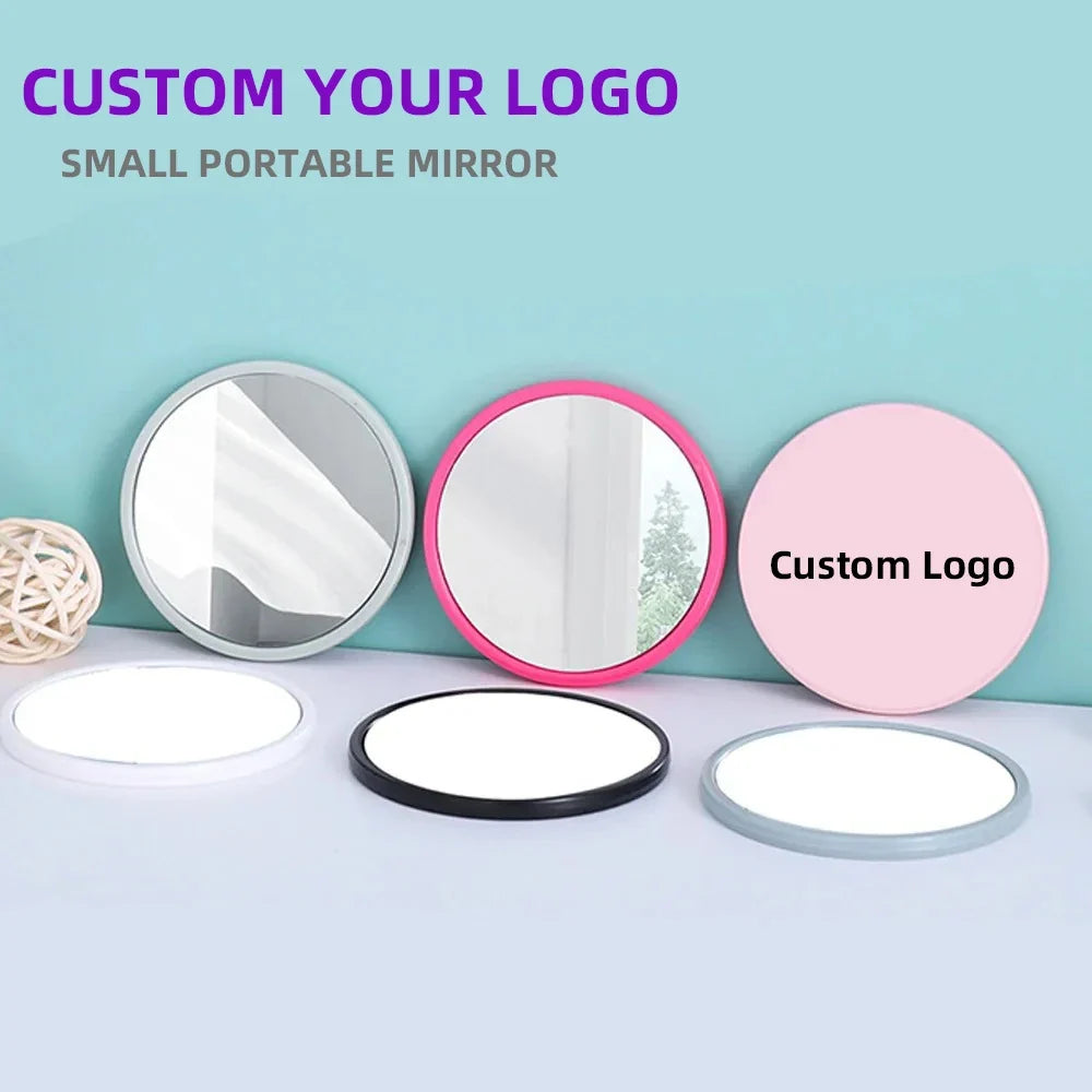 Small round pocket mirror by Blushimmer with customizable logo in red, pink, white, and black for wedding souvenirs or gifts.