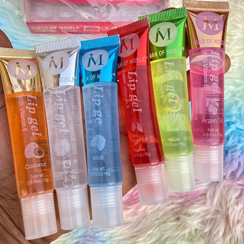 Set of 6 Blushimmer moisturizing clear lip glosses with rosehip, argan, peppermint, aloe, and coconut flavors in translucent lip oils.