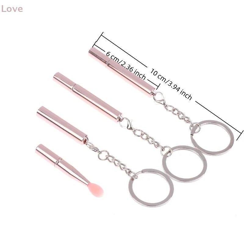 Blushimmer multifunctional silicone lipstick and eyeshadow brush with cover, portable keychain dustproof tool in black.