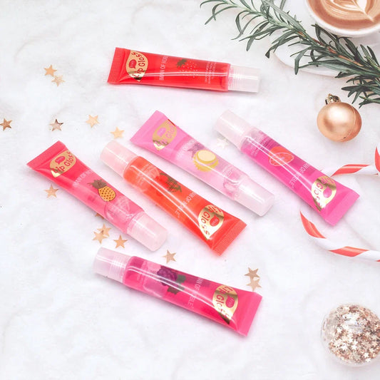 Set of 6 Blushimmer moisturizing clear lip glosses with pineapple, strawberry, and grape flavors in translucent plumping lip oils gift set.
