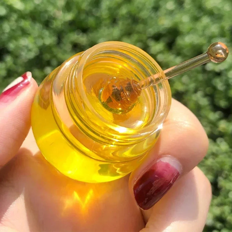 Transparent honey pot-shaped lip mask by Blushimmer, moisturizing and lightening lips, designed for overnight lip care and hydration.
