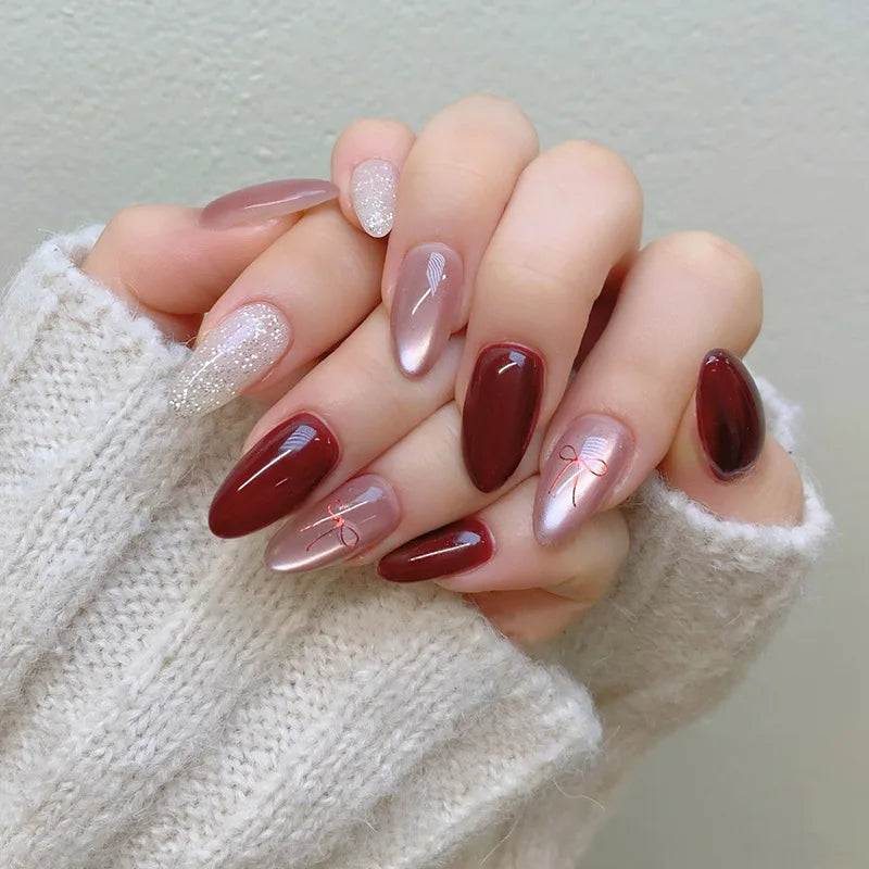 Set of 24 glossy red cat's eye press-on nails by Blushimmer, almond-shaped, full cover false nails with nude color and charms.