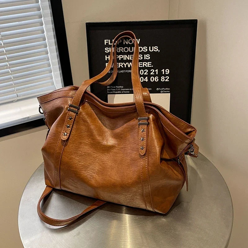 Brown leather women's tote shoulder crossbody bag by OBA, featuring spacious interior and versatile design for daily use.
