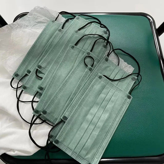 Set of 200 thickened tea green disposable face masks with elastic loops and adjustable nose clips for travel, outdoor activities, and casual wear