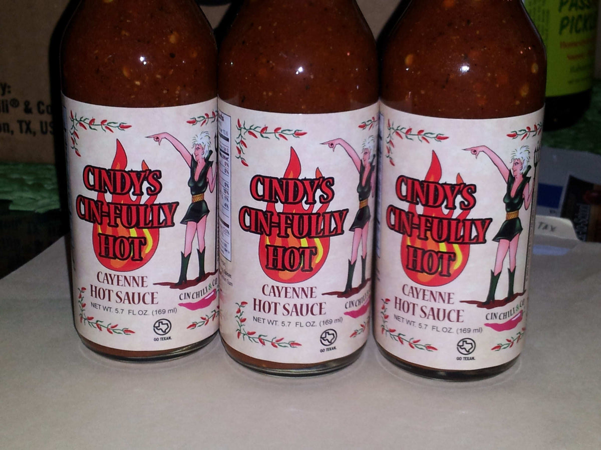 Cindy's Cin-fully Hot Cayenne Hot Sauce bottle from Cinderosa Ranch with fiery red hot sauce inside.