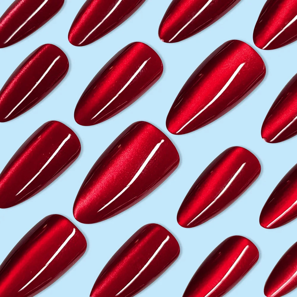 Set of 24 glossy red cat's eye press-on nails with nude almond shape by Blushimmer, featuring detachable charms for a stylish look.