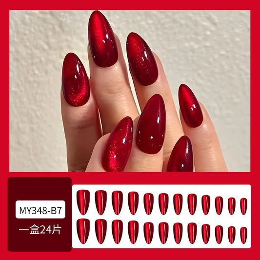 Set of 24 glossy red cat's eye press on nails by Blushimmer, almond-shaped, full cover false nails with nude color and detachable charms.