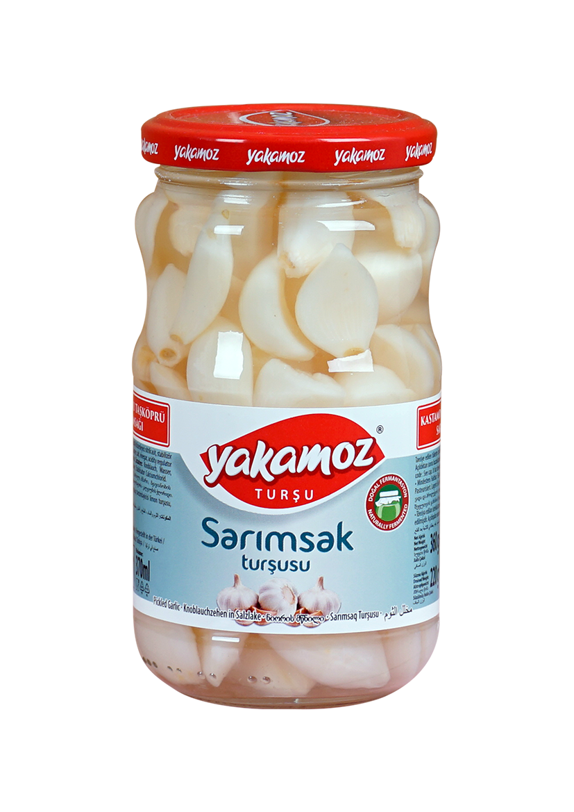 Glass jar of S101 Yakamoz pickled garlic, showing whole garlic cloves in brine, labeled as pickles in a clear glass jar.