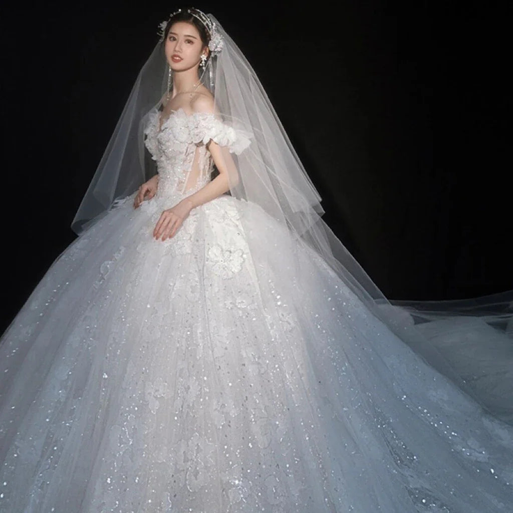 Luxurious EdleessFashion wedding gown with shiny applique and sweetheart neckline, perfect for elegant bridal attire.