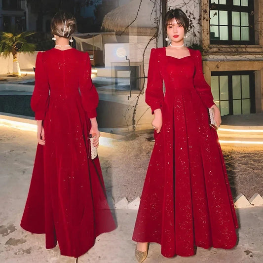 Elegant luxury red ceremony gown by Luxlife Brands, featuring intricate detailing and flowing fabric for formal occasions.