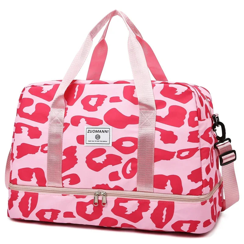 Pink women's OBA carry-on travel bag with duffel style, sturdy handles, and spacious main compartment for gym or travel use.
