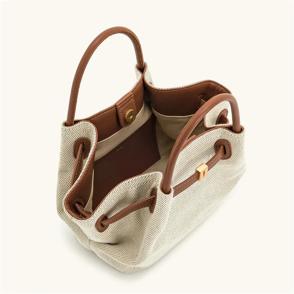 Women's brown canvas mini crossbody shoulder bag by OBA with adjustable strap and compact design, perfect for everyday carry.