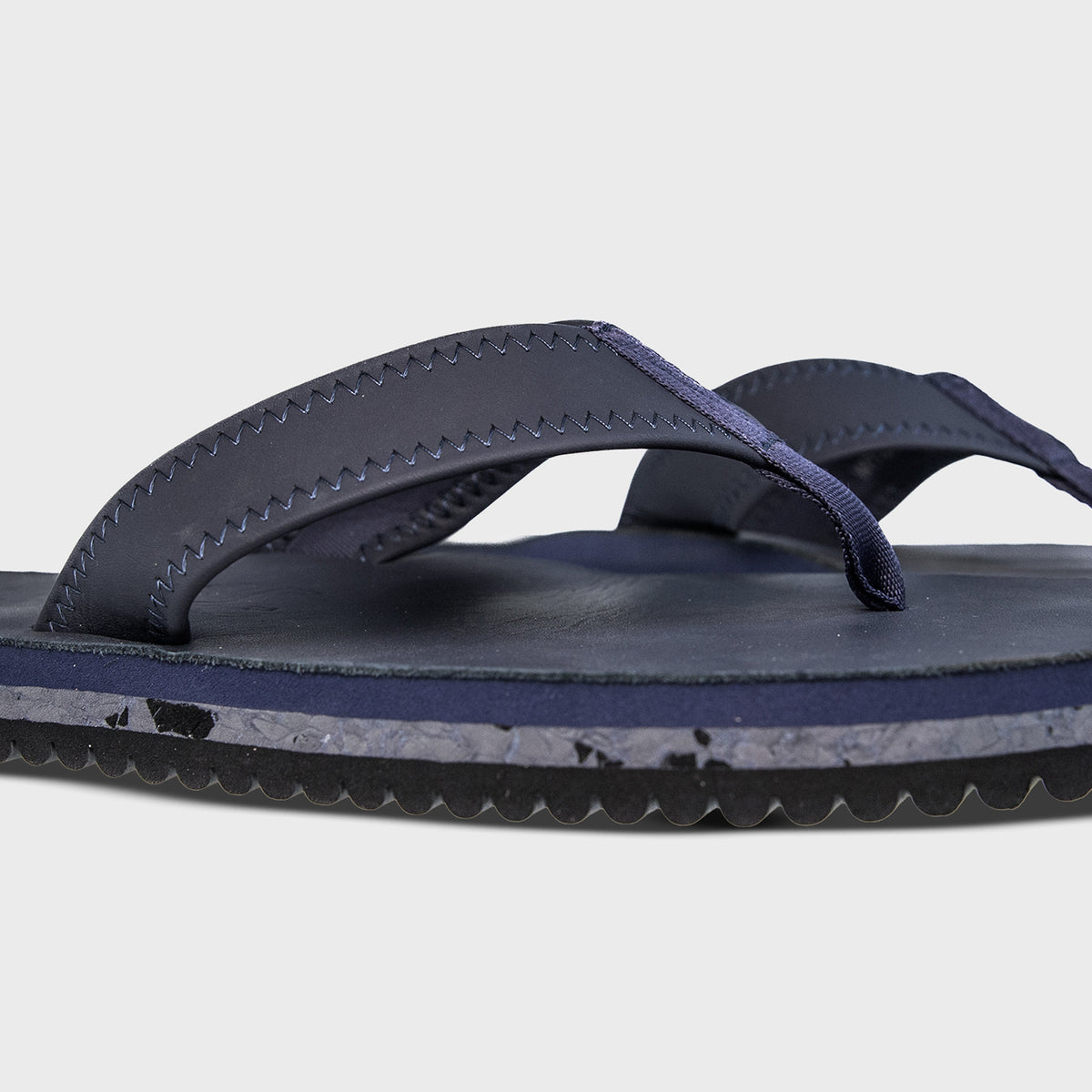 Pair of Fleks Seagrove Flip Flops in deep blue sea color, featuring comfortable strap design and casual summer style.