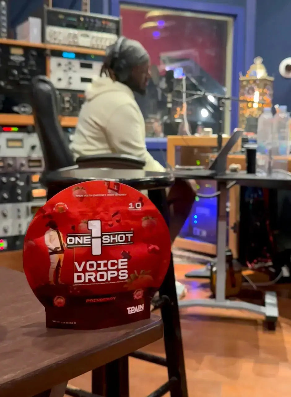 T-Pain in the studio with 1 Shot Energy Voice Stack bundle, featuring voice drops and recording equipment for professional audio.