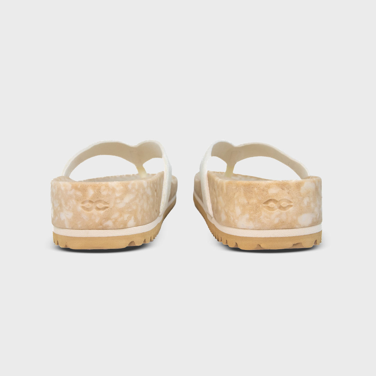 Pair of Fleks West Beach Flip Flops in oatmeal color, showing the rear view of the casual slip-on sandals.