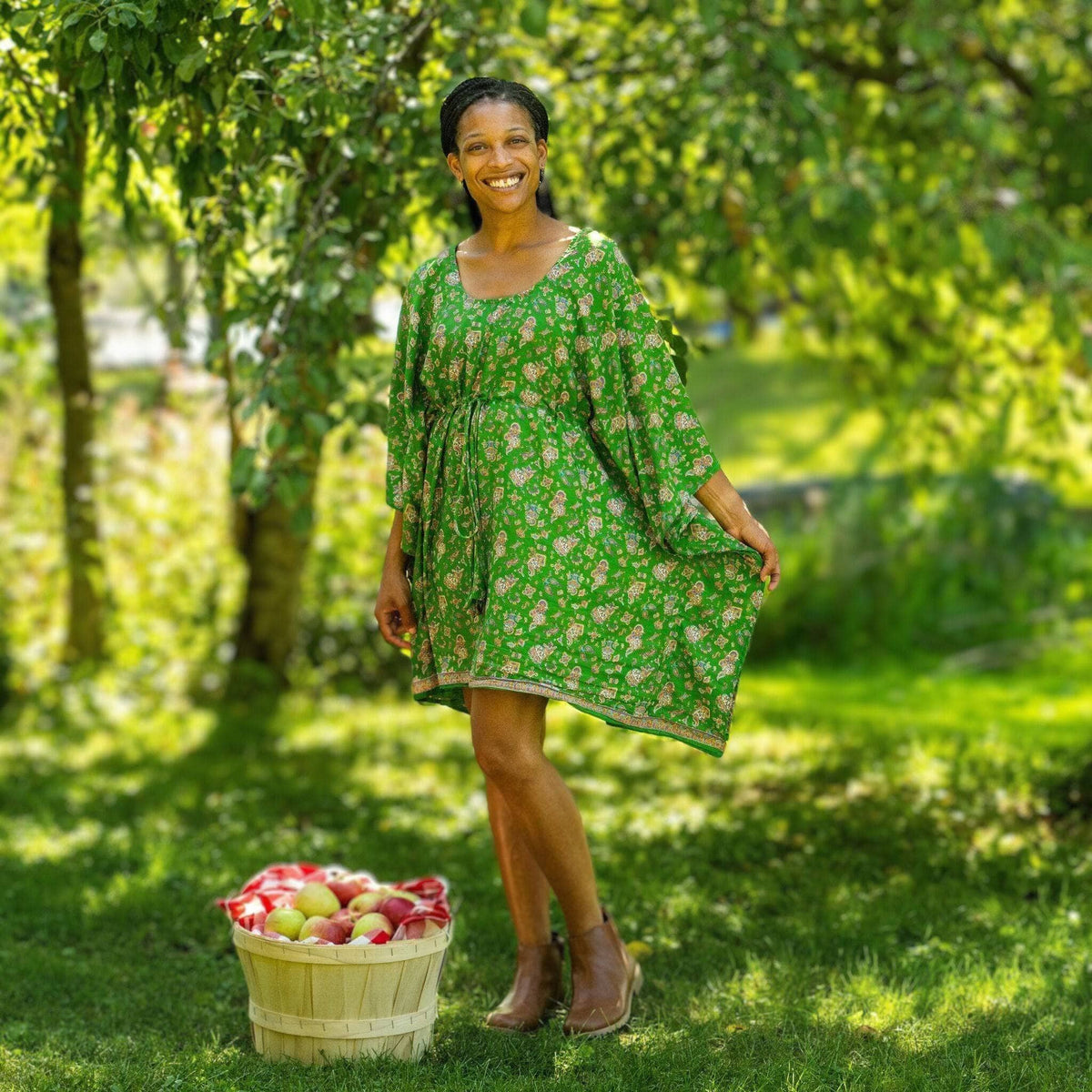 A woman wearing the Darn Good Yarn Surplus Aanya Adjustable Short Kaftan in eco-friendly crochet, plus size, boho style.