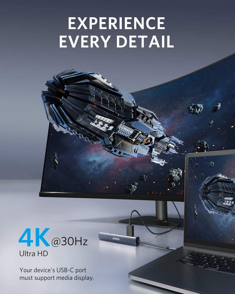 Anker 543 USB-C Hub, slim 6-in-1 charging hub with multiple ports, shown in black with connected devices.