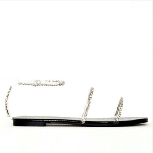 Flat women's beach sandals by BACKUPMYFILESNOW.COM® with tan straps and flat soles, perfect for casual summer wear.
