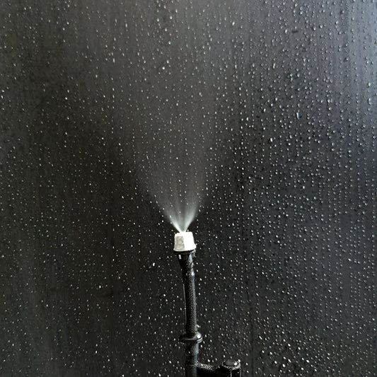 OAISI 20-pack plastic garden misting sprinkler heads with nozzles and tee joints for watering and irrigation systems.