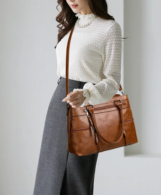 Black elegant women's handbag with top handle, PU leather, shoulder strap, and spacious tote design for casual or crossbody wear.