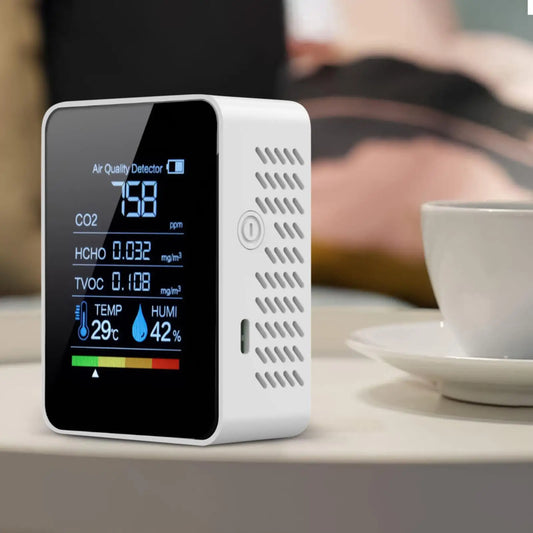 Black smart air quality monitor displaying CO2, temperature, and humidity levels for home, bedroom, living room, car, or office.
