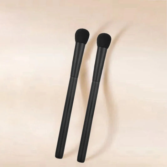 High-quality flat blush makeup brush with synthetic hair and black handle, designed for precise cheek application.