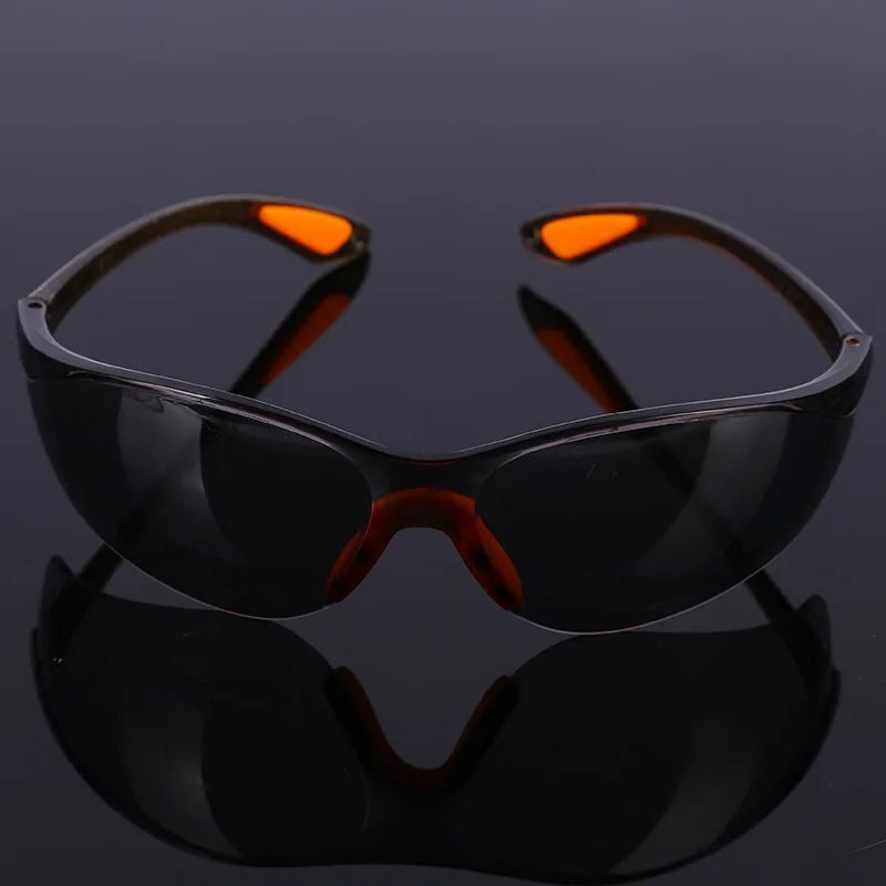 Unisex industrial safety goggles with anti-splash, dustproof, windproof design for cycling and work eye protection.