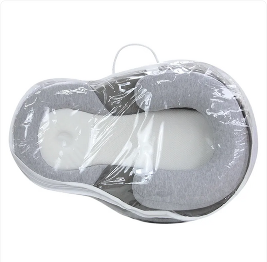 Light grey Baby Anti-Spit Up Pillow with safety strap, designed to keep infants comfortable and reduce spit-up.