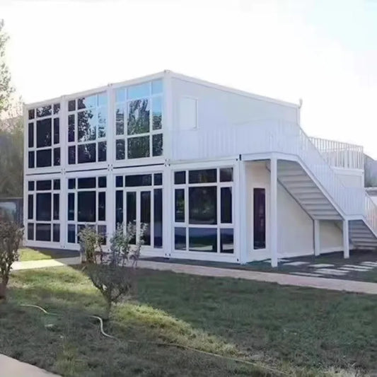 Gray modular tiny house with 3 bedrooms, 2 bathrooms, featuring a container kitchen and mobile prefabricated design.