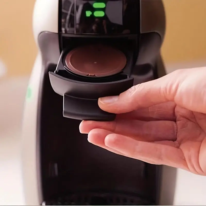 Red reusable coffee capsule filter for coffee machine, designed for easy brewing and eco-friendly use.