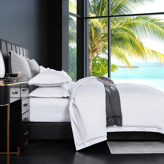 White bedding set with duvet cover, sheets, and pillowcases in queen and king sizes, designed for luxury hotel-style home bedding.