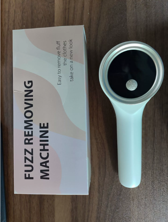 White rechargeable fabric and lint shaver by BackupMyFilesNow.com with a handheld design and textured shaving head.