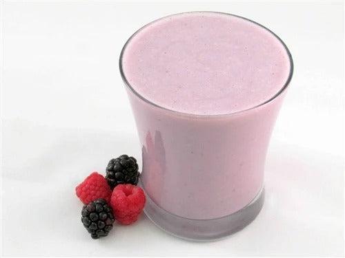 Creamy Berry Fusion smoothie in a glass, made by AmBari Nutrition, featuring fresh berries and a vibrant purple color.