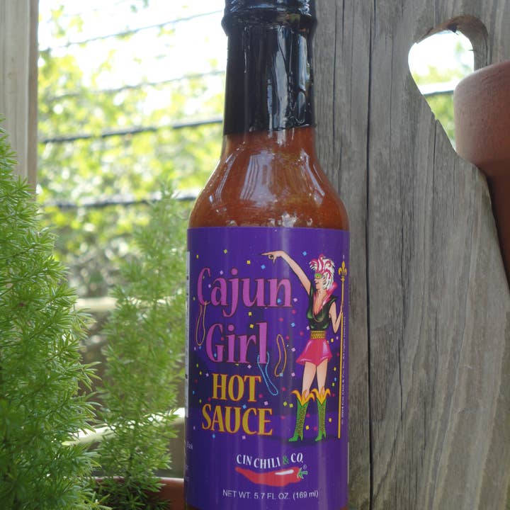 Cinderosa Ranch Cajun Girl Louisiana-Style Hot Sauce bottle with red and yellow label on a white background