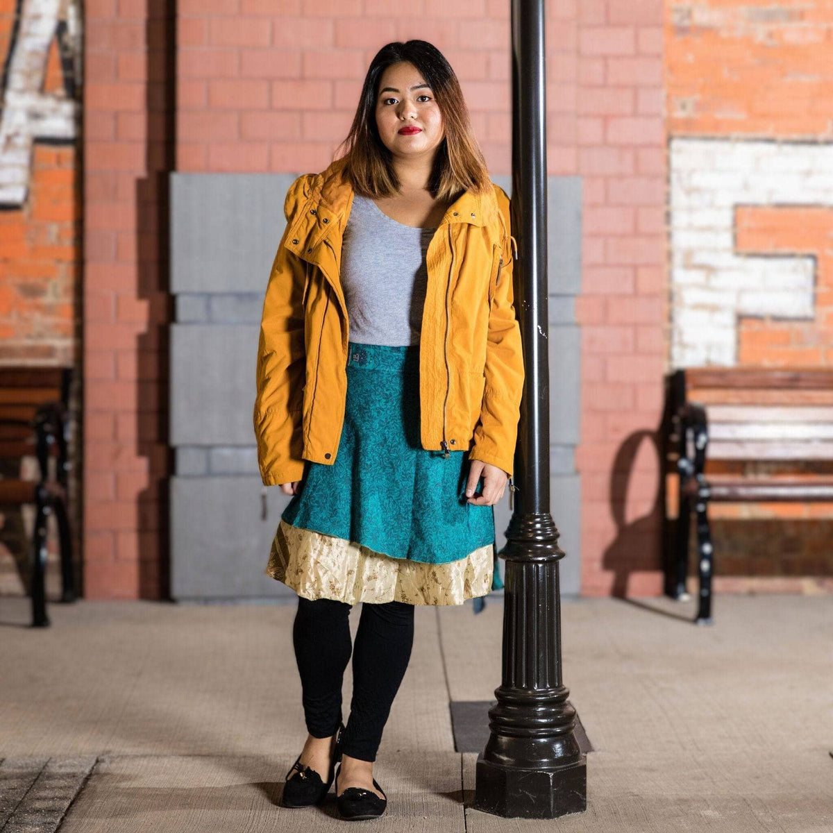 Knee-length mini sari wrap skirt in warm tones by Darn Good Yarn, featuring vibrant, colorful traditional clothing and accessories.