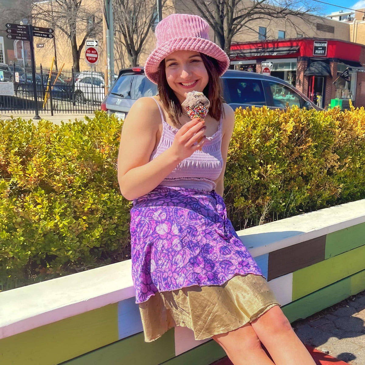Knee-length mini sari wrap skirt by Darn Good Yarn in warm tones, showcasing vibrant fabric and traditional wrap style.