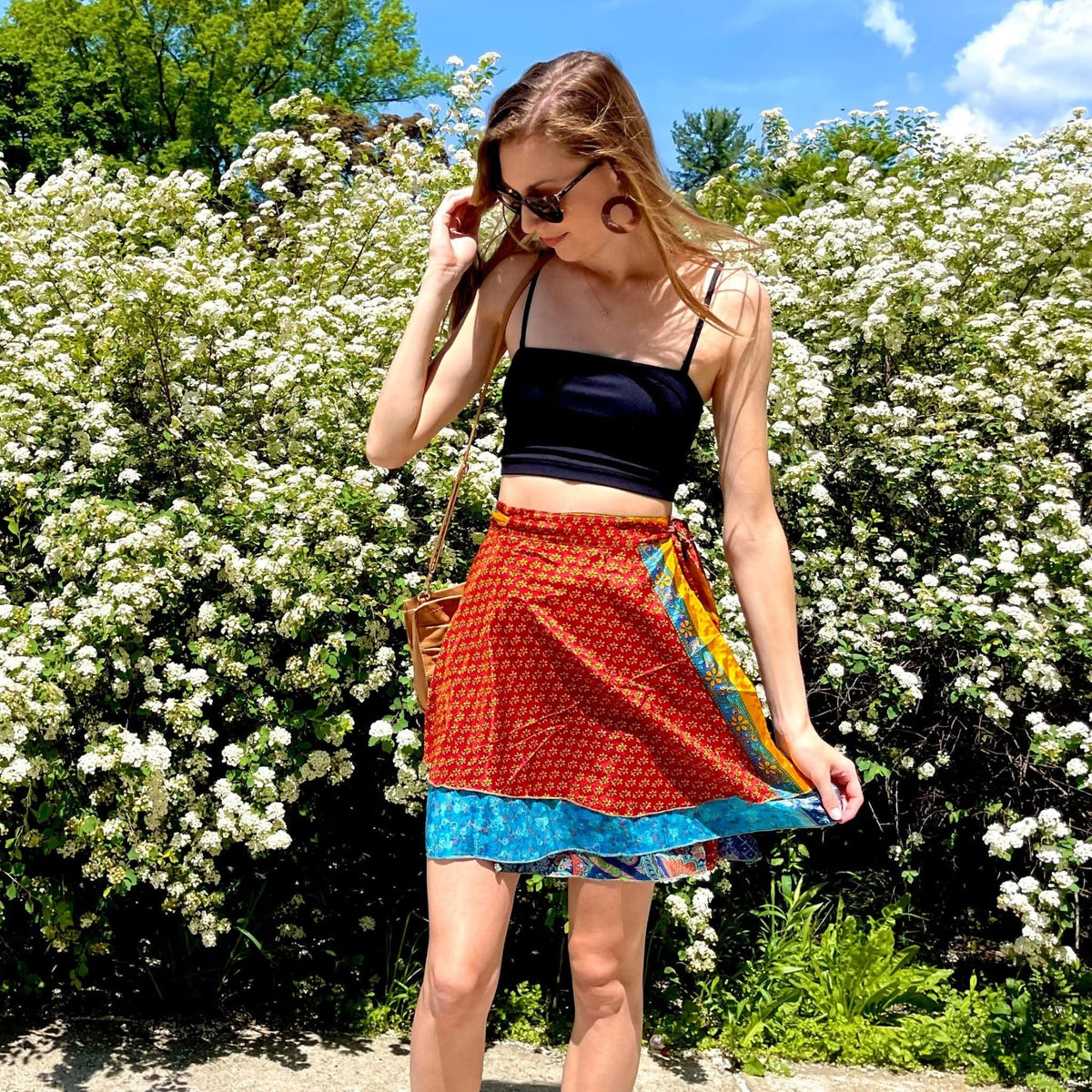 Knee-length mini sari wrap skirt by Darn Good Yarn in warm tones, featuring vibrant fabric and traditional wrap style.
