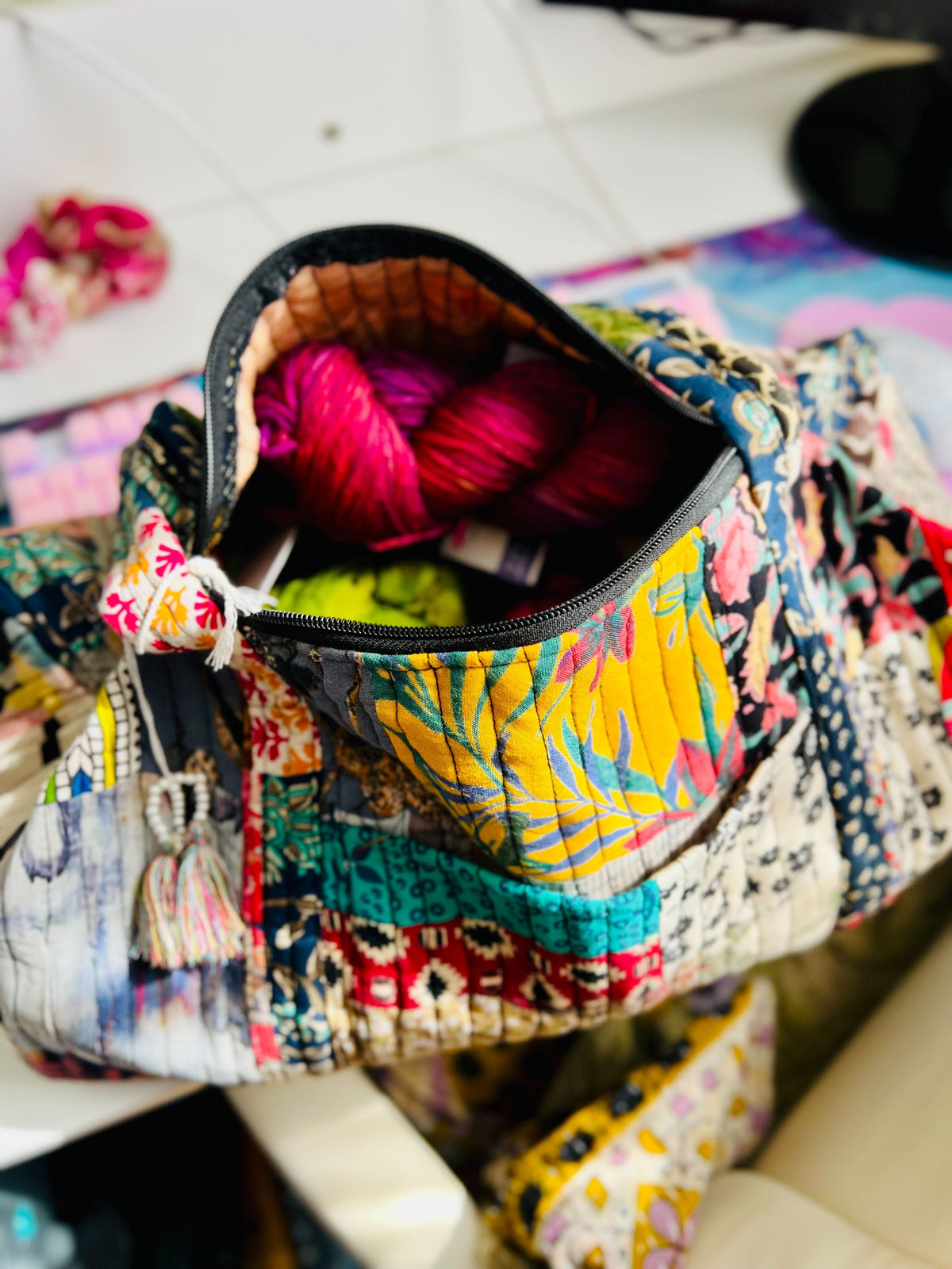 Colorful patchwork quilted duffle bag from Darn Good Yarn, stylish and spacious for travel or everyday use.