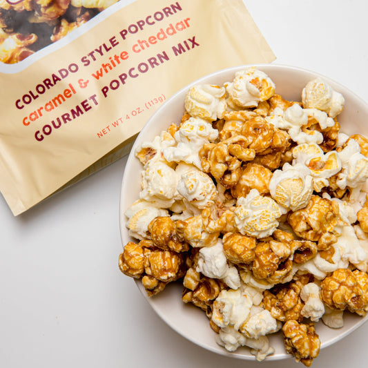Colorado Style Popcorn by Colorado Popcorn Company in a 4 oz bag with crunchy, golden popcorn kernels and colorful packaging.