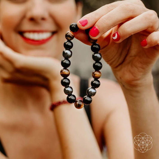 Conscious Items Triple Protection Bracelet featuring layered black and silver beads on a durable cord.