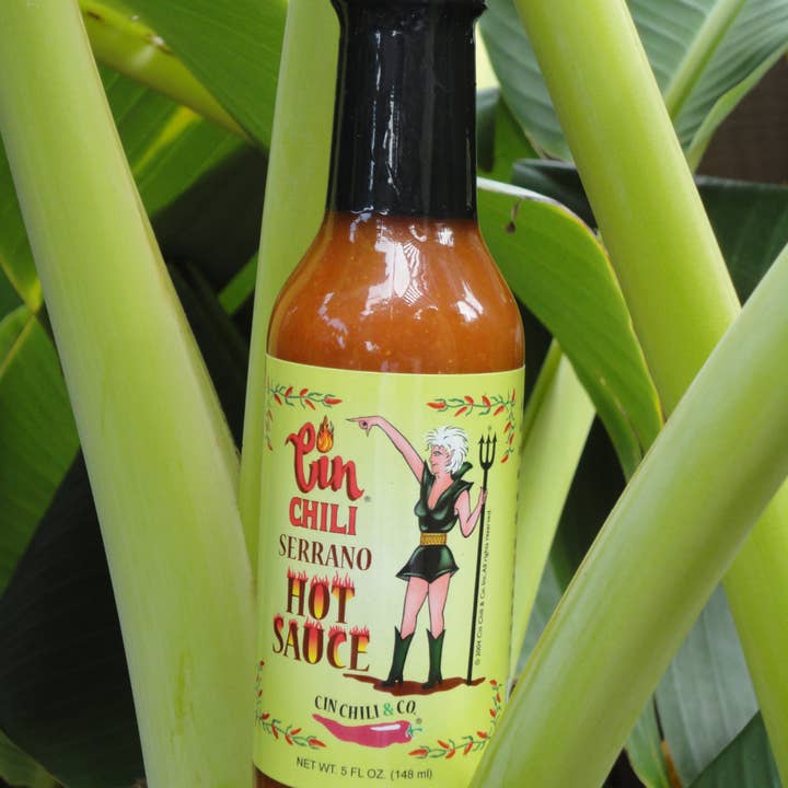 Cinderosa Ranch Cin Chili Seasoning and Serrano Hot Sauce combo in jars, spicy chili seasoning with fresh green Serrano peppers