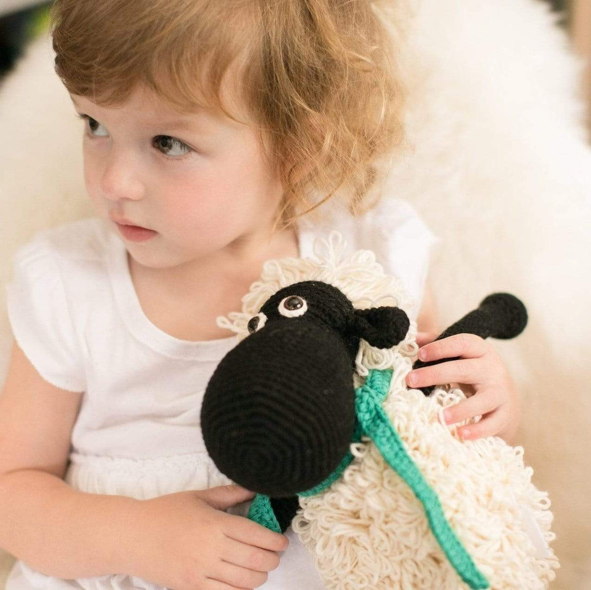 Black handmade stuffed sheep named Shelly by Bebemoss, made from organic cotton with detailed woolly texture.
