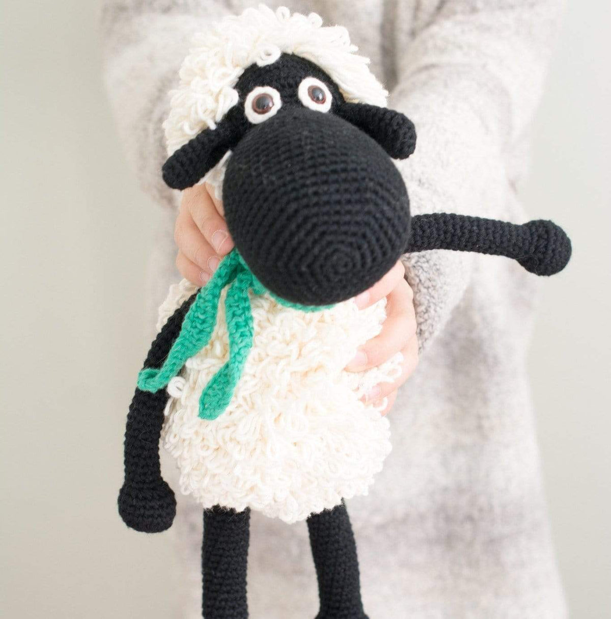 Black handmade Shelly the sheep stuffed animal by Bebemoss, made from organic cotton with detailed woolly features.