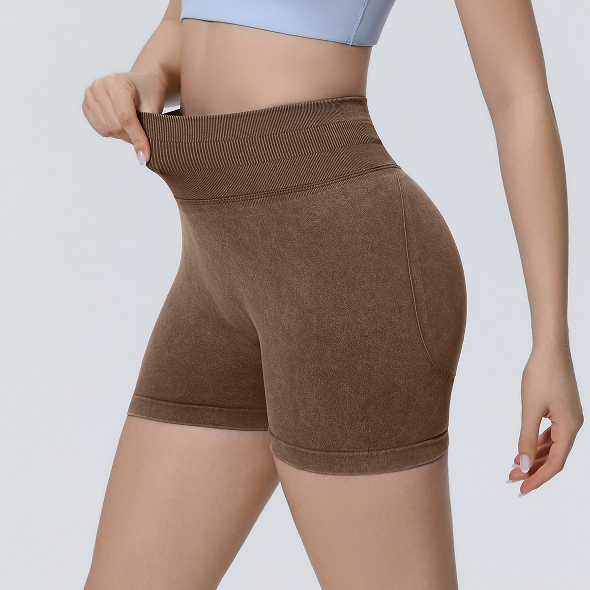 Seamless knitted sand-washed yoga shorts in a neutral tone, front view